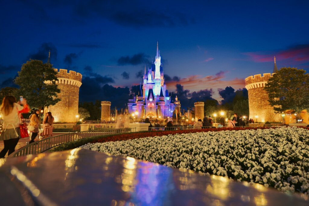 Tokyo Disneyland entrance with Cinderella Castle and vibrant theme park atmosphere.