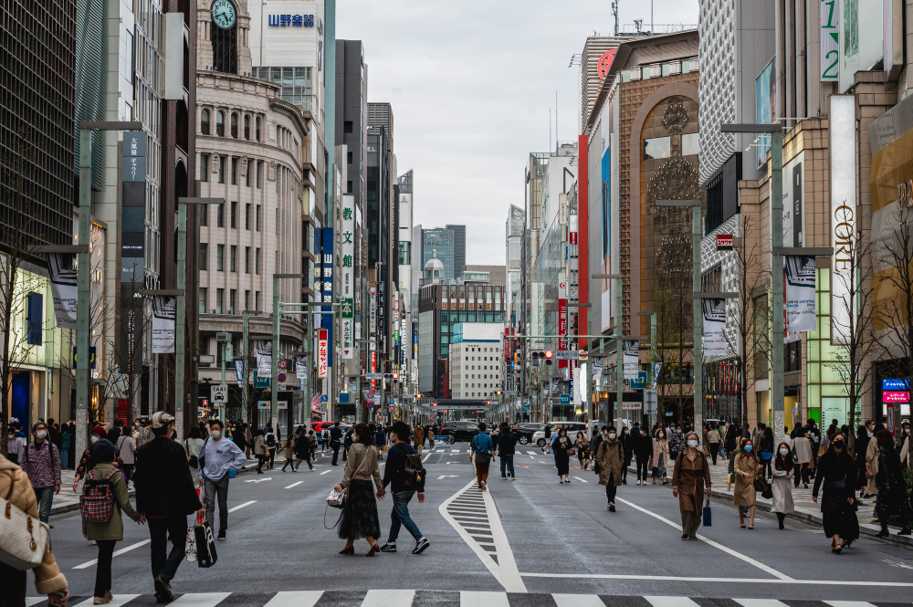 Crowd of people walking through the busy streets of Tokyo, Japan.