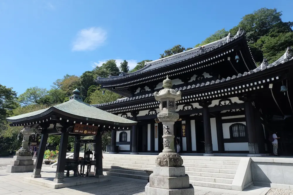 Hase-dera Temple in Kamakura featuring wooden halls, Buddhist statues, and scenic gardens overlooking the sea in Japan.
